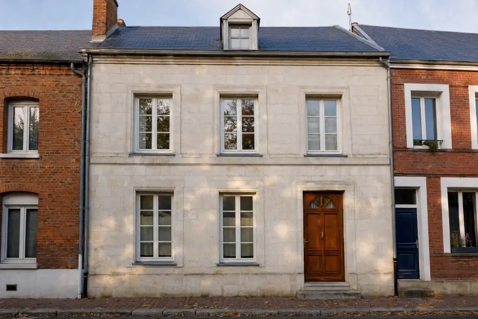 Light stone townhouse with a wooden front door