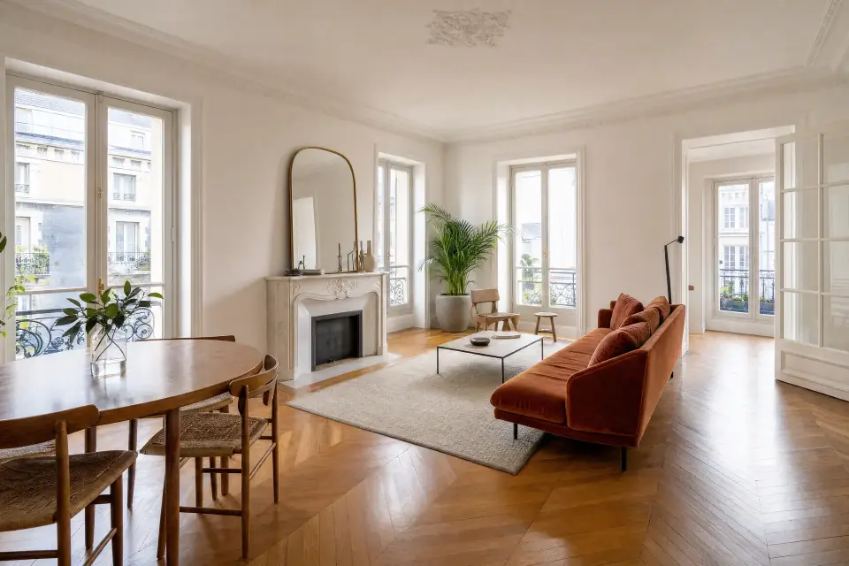 Living room with hardwood floors and tall windows